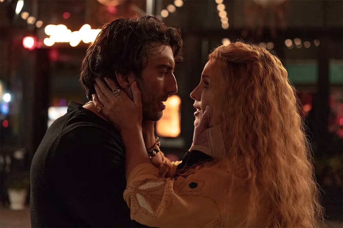 A screen capture from the 'It Ends With Us' movie. Two characters look into each other's eyes as they hold their faces.