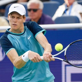 Jannik Sinner hitting the tennis ball