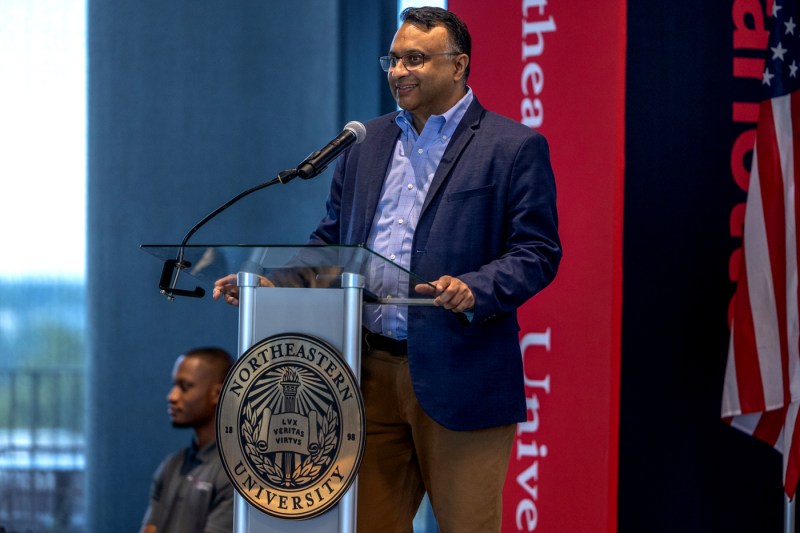 Dr. Rahul Gupta speaking at a podium.