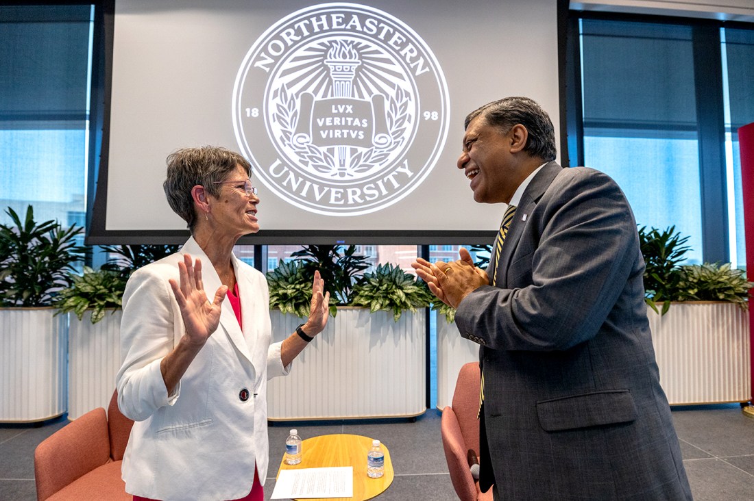 Dr. Rahul Gupta speaks with another person on the campus of Northeastern University in Charlotte, North Carolina.