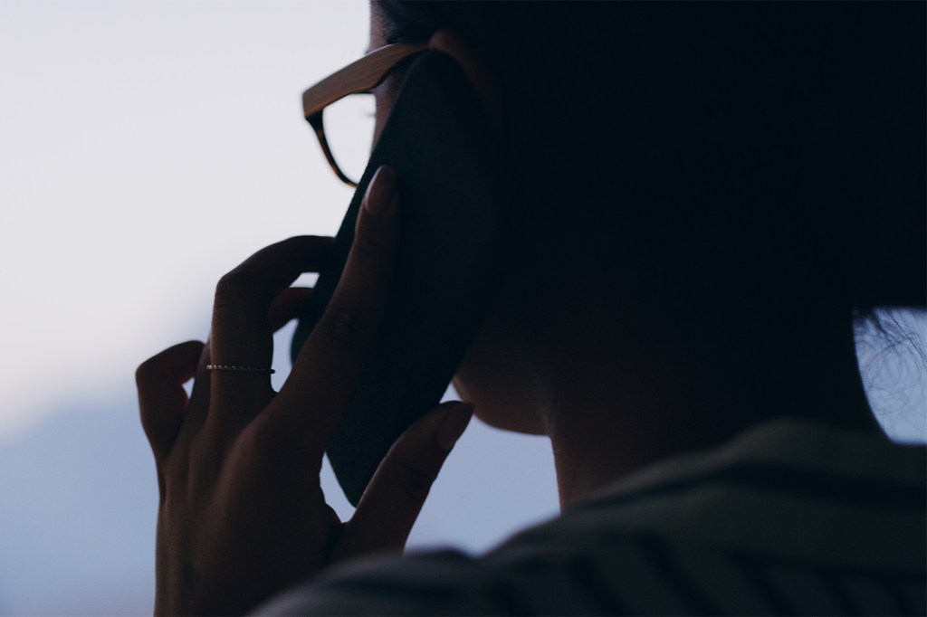 Silhouette of a person making a phone call.