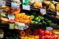 Rows of bell peppers in the grocery store.