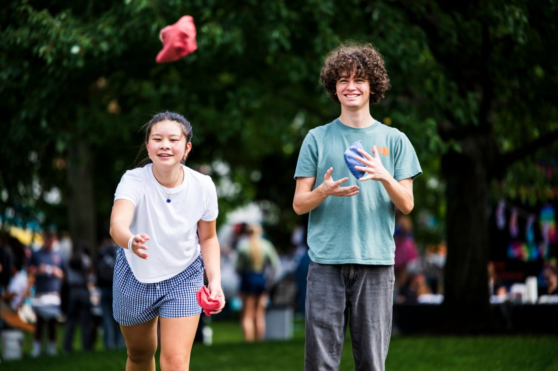 Two people play corn hole together during Northeastern's Welcome Week.