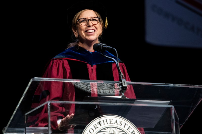 Mary Ludden speaking on stage at Convocation.