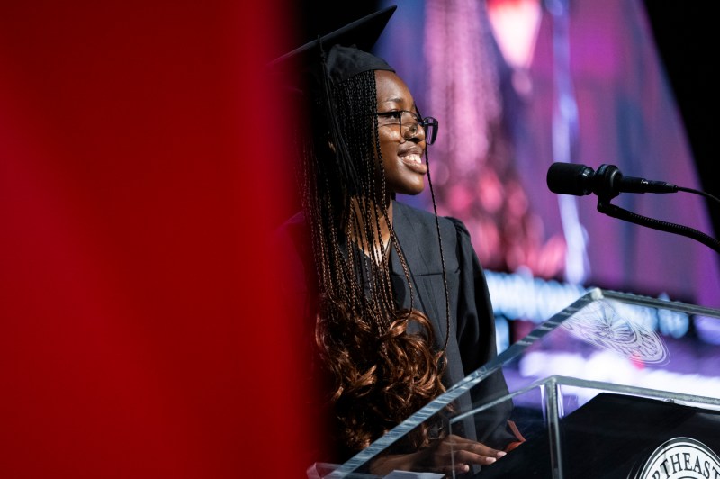 A student speaking on stage at Convocation.