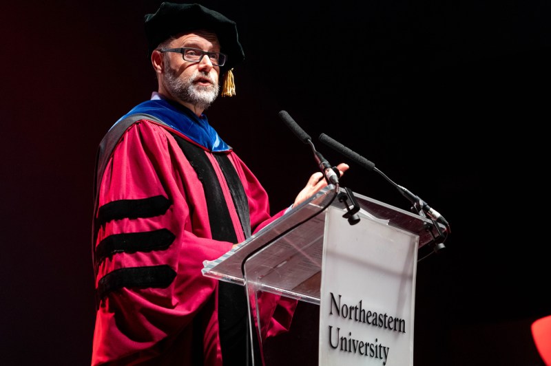 A university leader speaking on stage at Convocation.