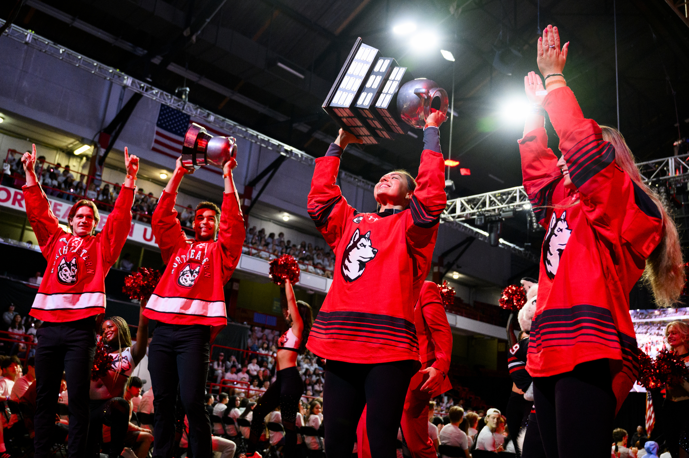 Northeastern hockey players holding up beanpot tropheys at Convocation.