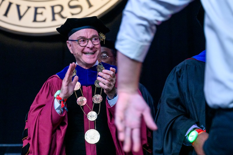 President Aoun clapping on stage at Convocation.