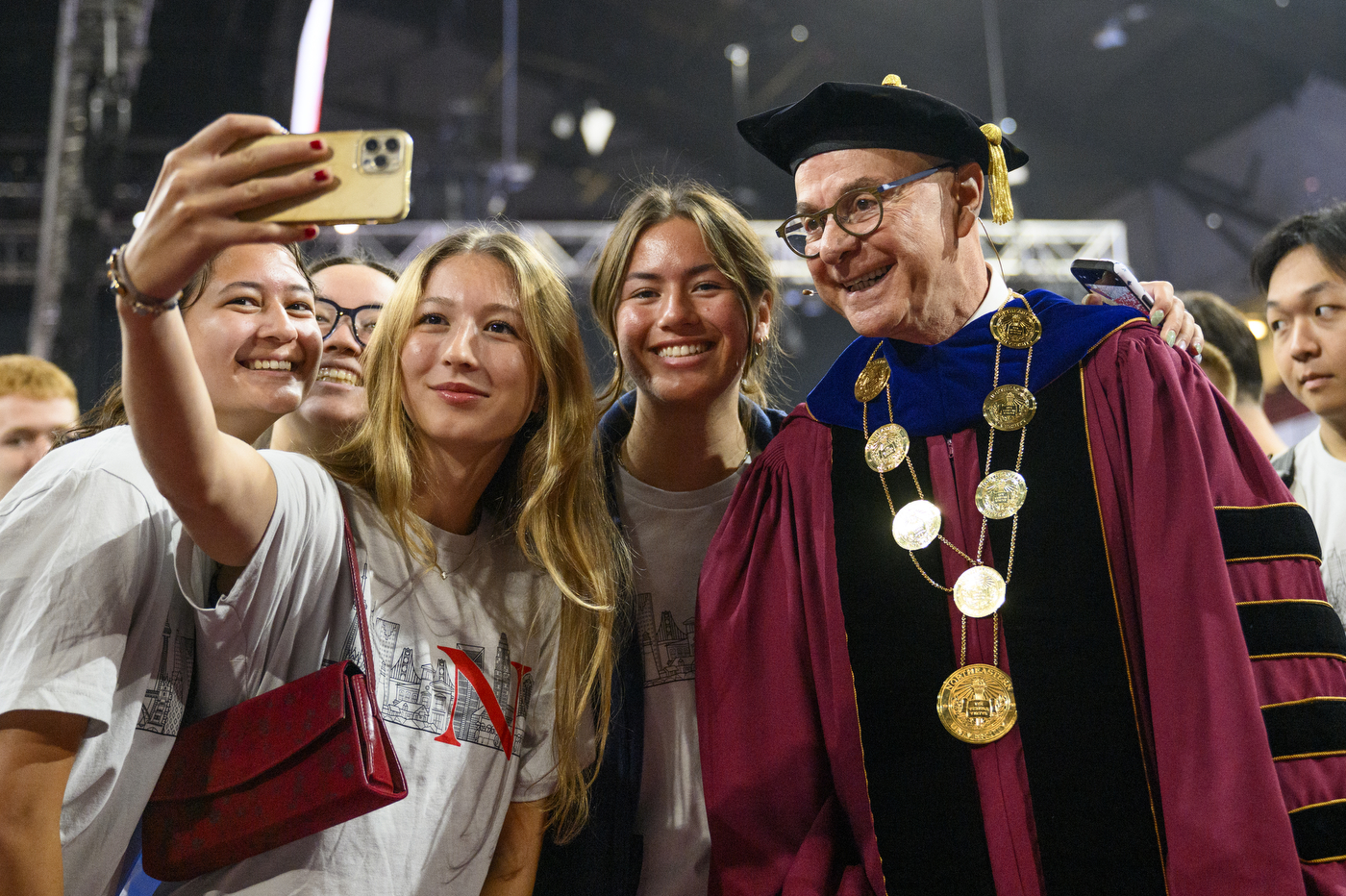 Students taking a selfie with President Aoun at Convocation.