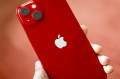 A person holding a red iPhone.