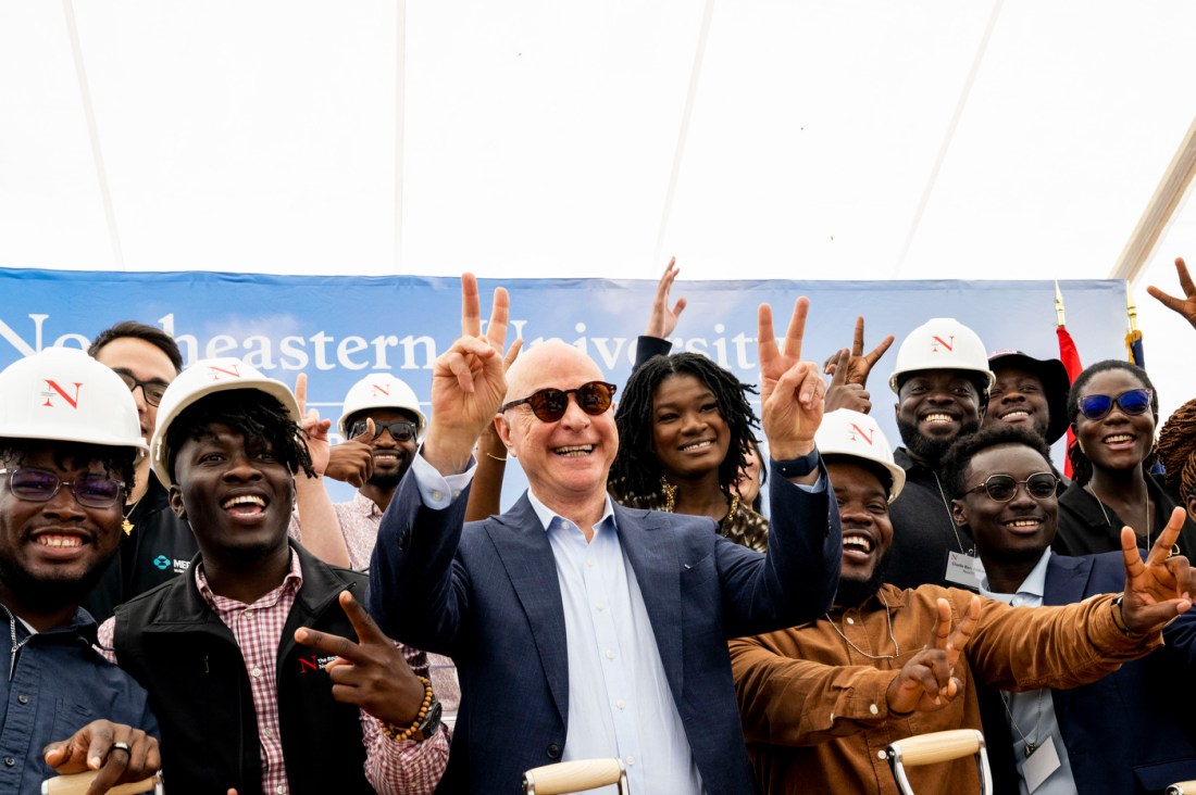 President Aoun posing with people wearing hard hats at the Portland campus ground breaking.