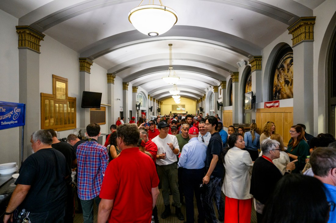 A hallway full of facilities workers at a BBQ.