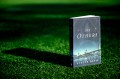 Evette Davis's new book 'The Others' standing upright on turf.