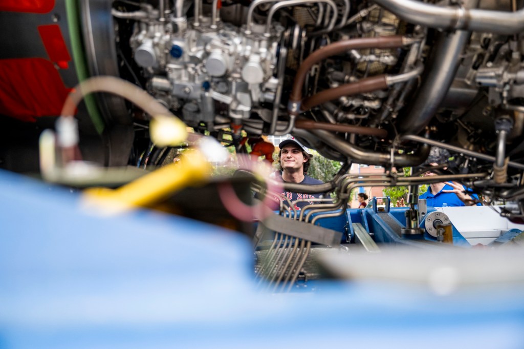 a student looking at a LEAP engine.