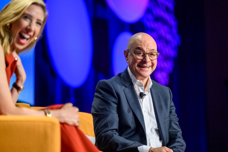 Claire Goldsmith and President Aoun laughing on stage.