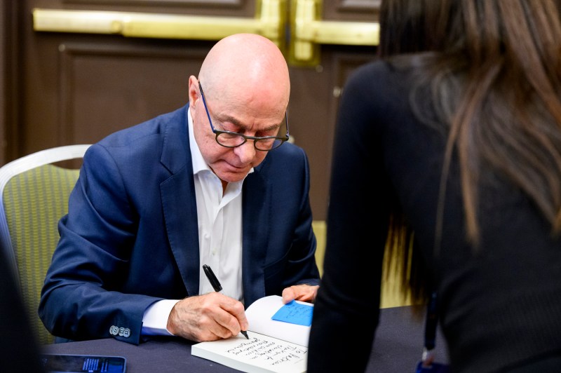 President Aoun signs a copy of his book, 