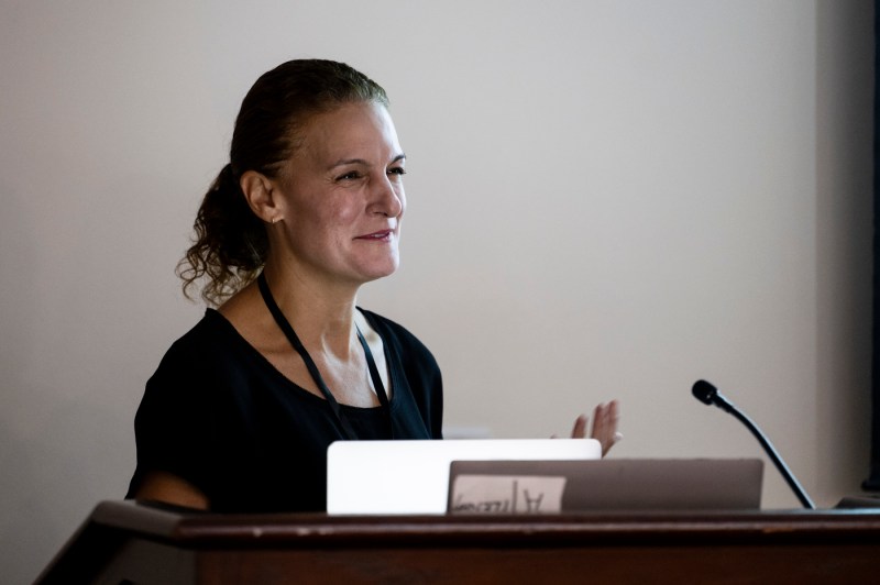 Rehecca Carrier speaking at a Symposium.