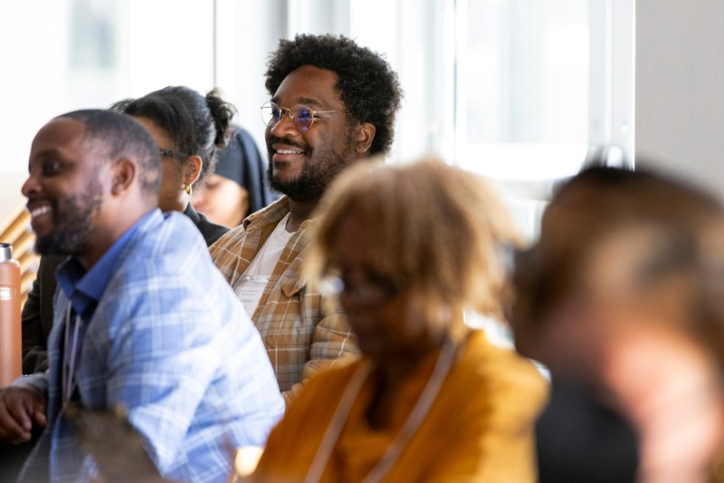 Torre Williams smiling while listening at the AI workshop.