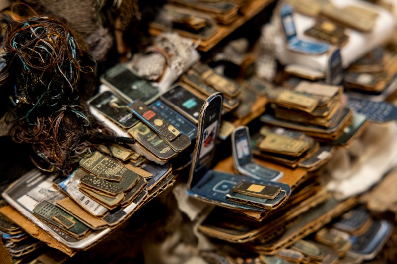 Stacks of old cellphones on display at the Mills College Art Museum.