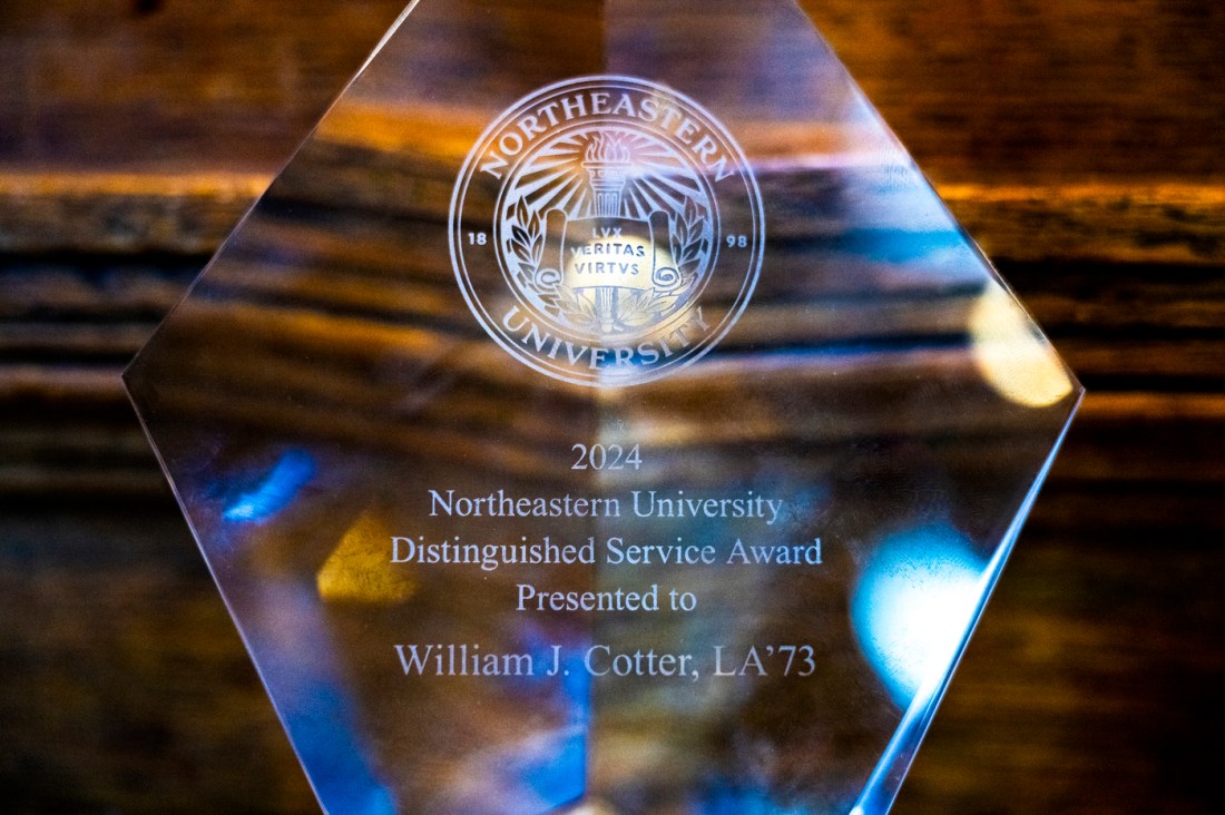 Close-up of a Northeastern University plaque displayed during a ceremony.