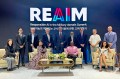 A group of people posing at the REAIM Summit.