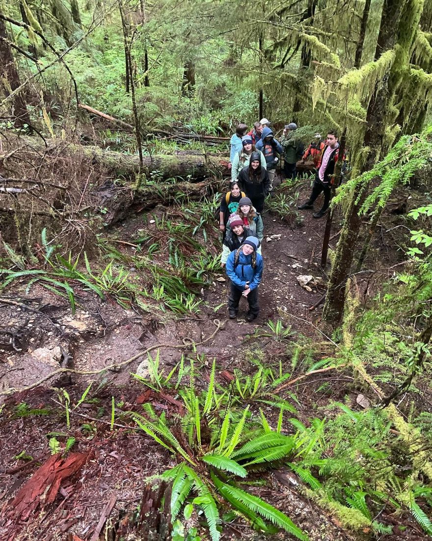 Students posing together in an old-growth forest.