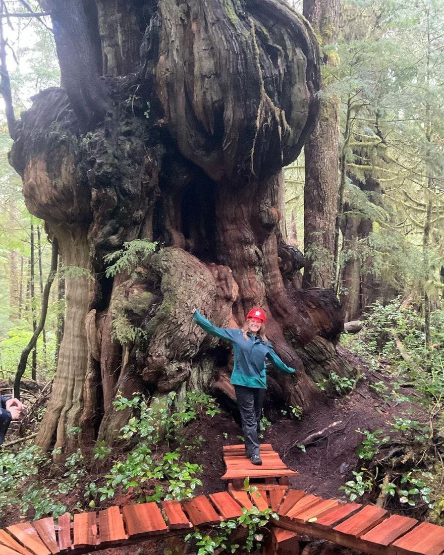 A student posing in front of a tree.