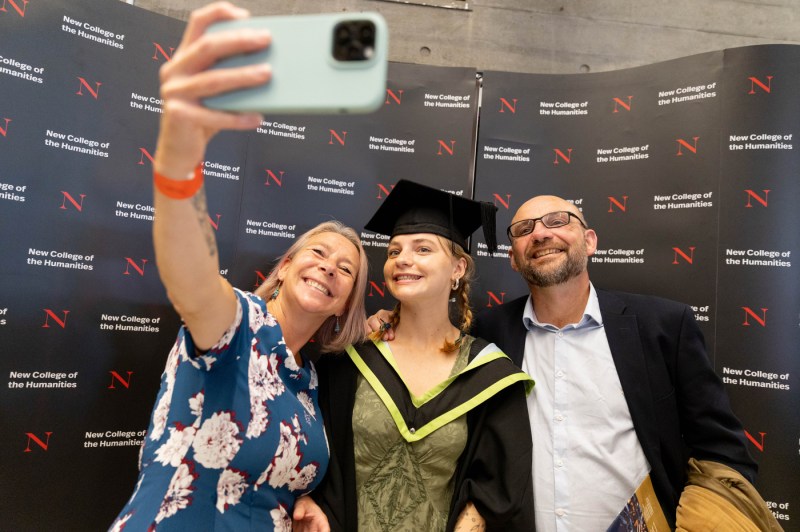 A graduate taking a selfie with their family.