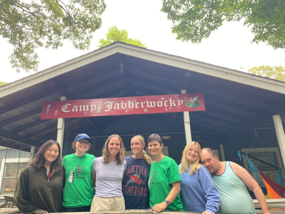 Kim Ho and students posing in front of the Camp Jabberwocky sign.