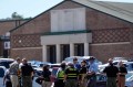 Police gathered outside the high school after a shooting.