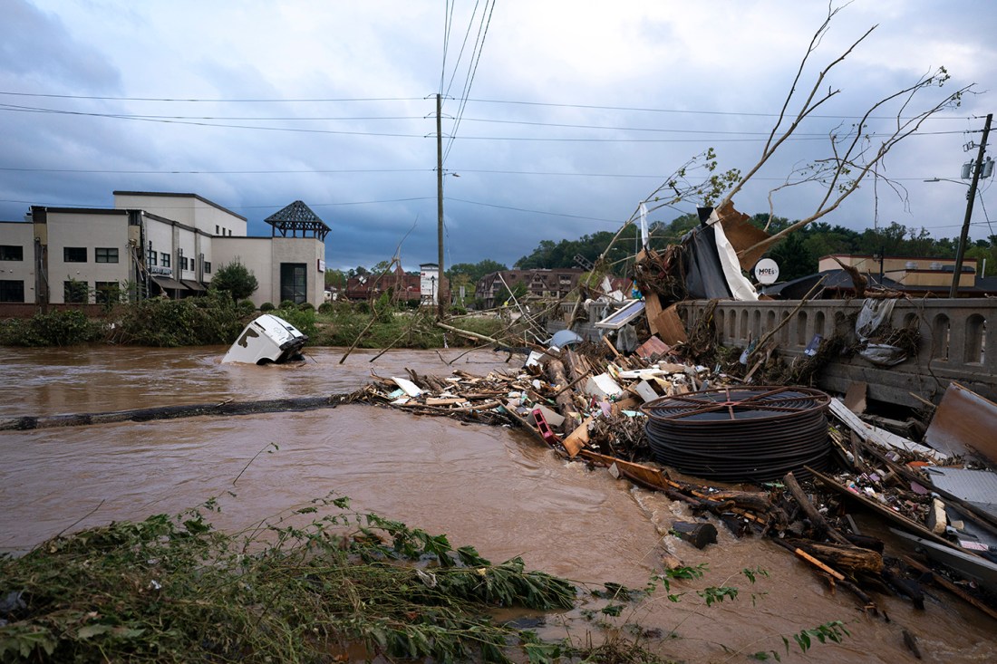 A flooded area of Nashville with a white van partially submerged in water.