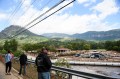 Three people looking over a bridge at the flooding in North Carolina.