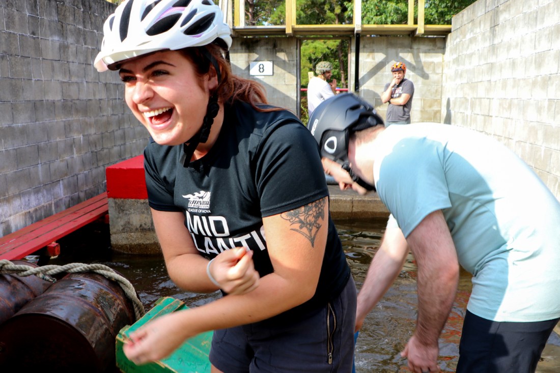 A student wearing a white helmet laughing.