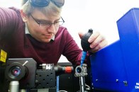 James Kneller working in a lab on a physics experiment.