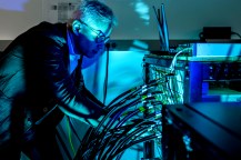 Tommaso Melodia at work at a box with many wires coming from it.