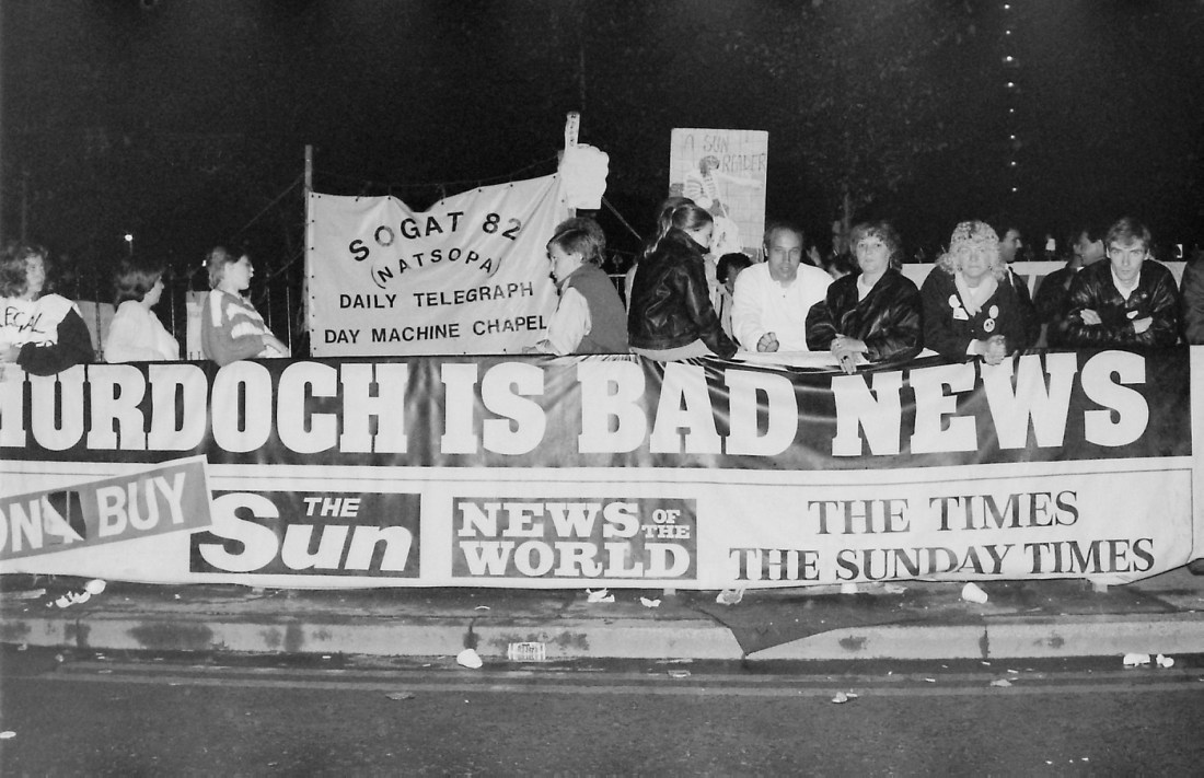 A black and white photo of people holding a banner that says 'Murdoch is bad news'.