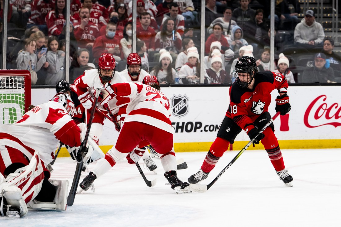 Skyler Irving shooting the puck on net at the Beanpot game.