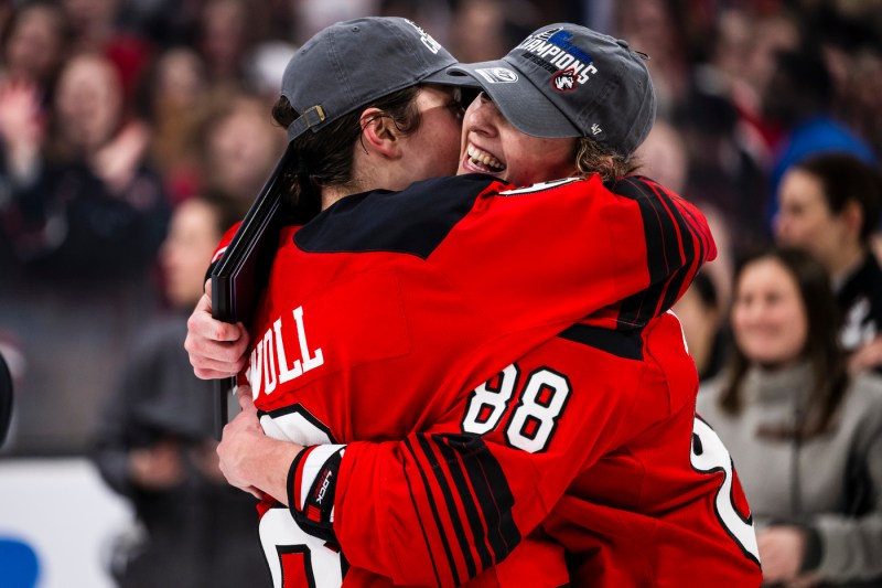 Skyler Irving and another player hugging each other after winning the Beanpot.