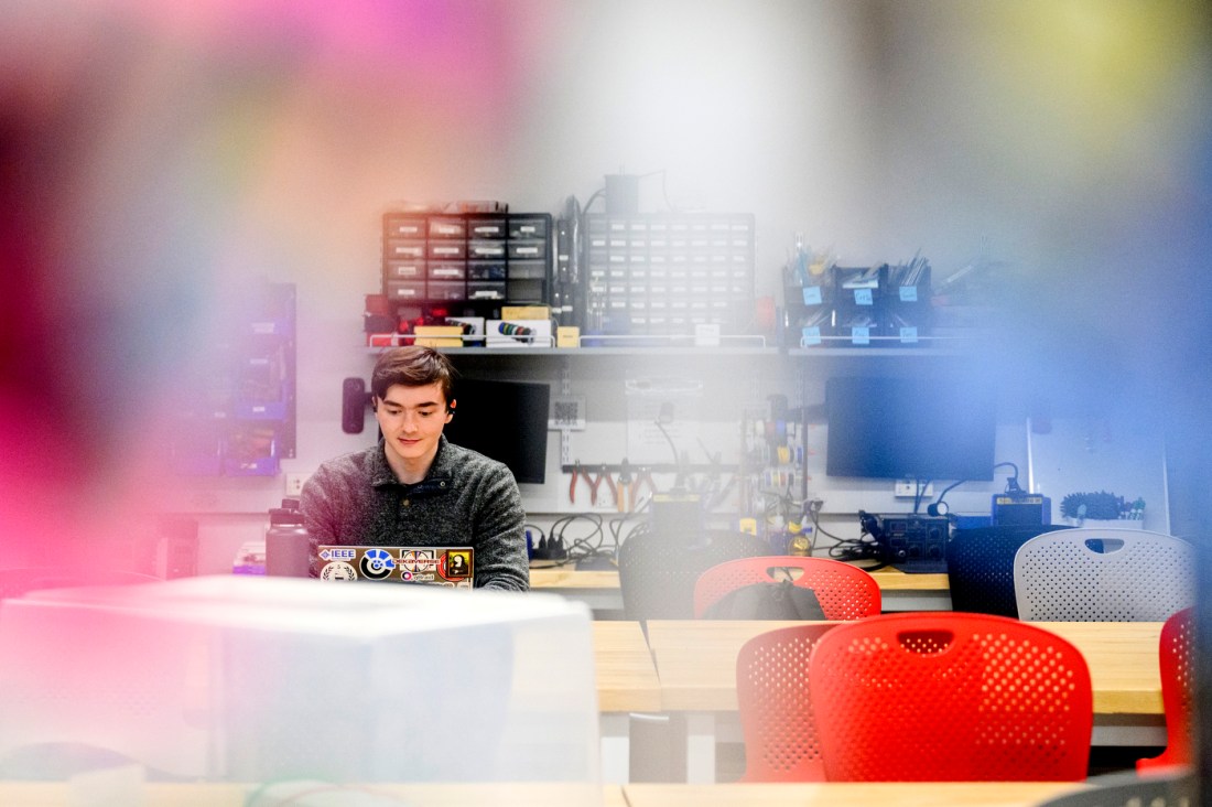 A student working on a laptop in the Sherman Center for Engineering entrepreneurship.