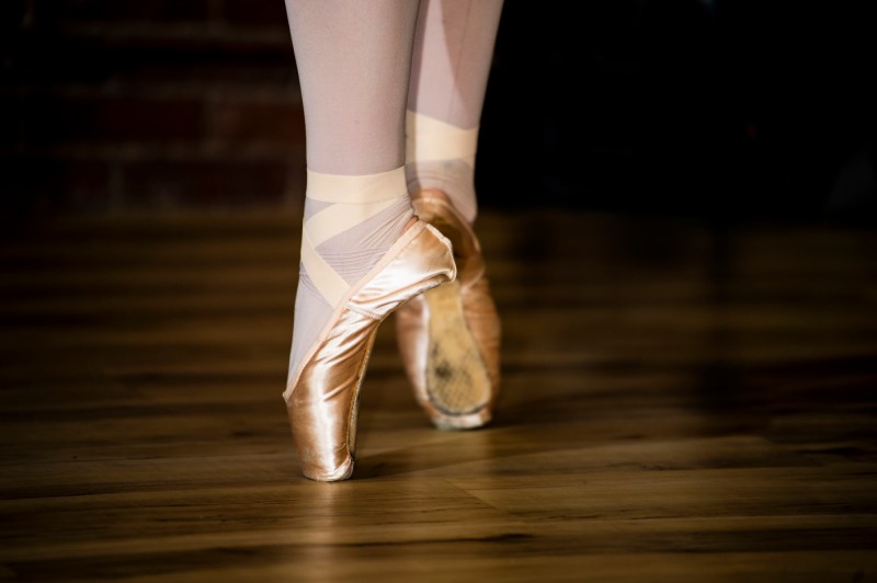 A ballet dancer's shoes as they stand in pointe. 