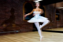 A ballet dancer in motion during a studio rehearsal.