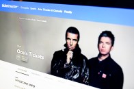 A computer monitor displaying the Ticketmaster web page for purchasing Oasis tickets.