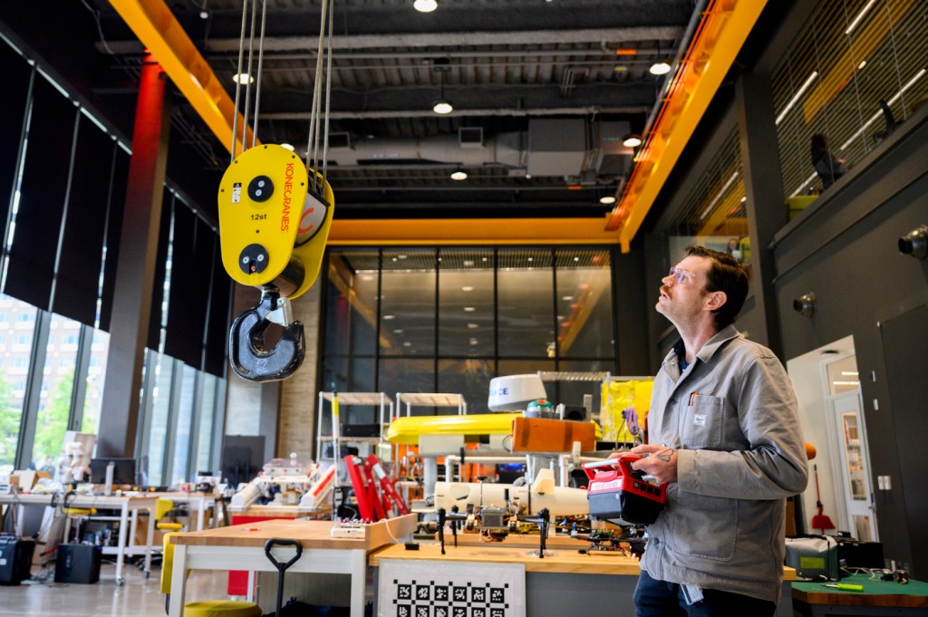 A person operates equipment in a robotics lab.