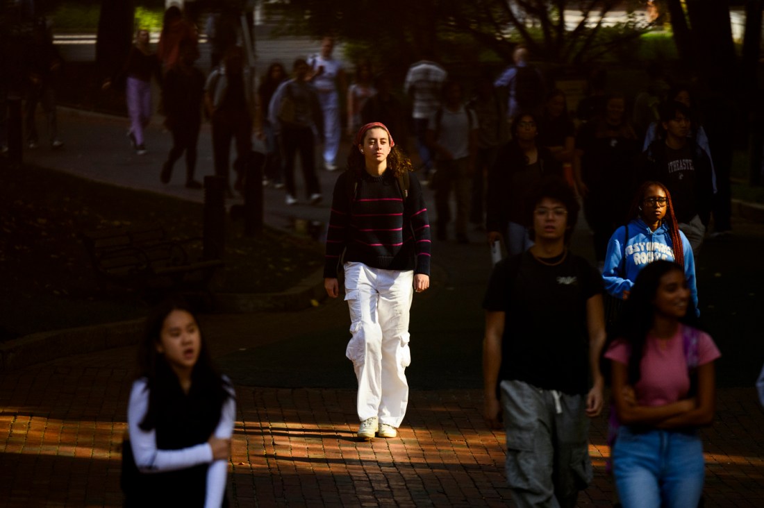 Students walking outside on a sunny day.