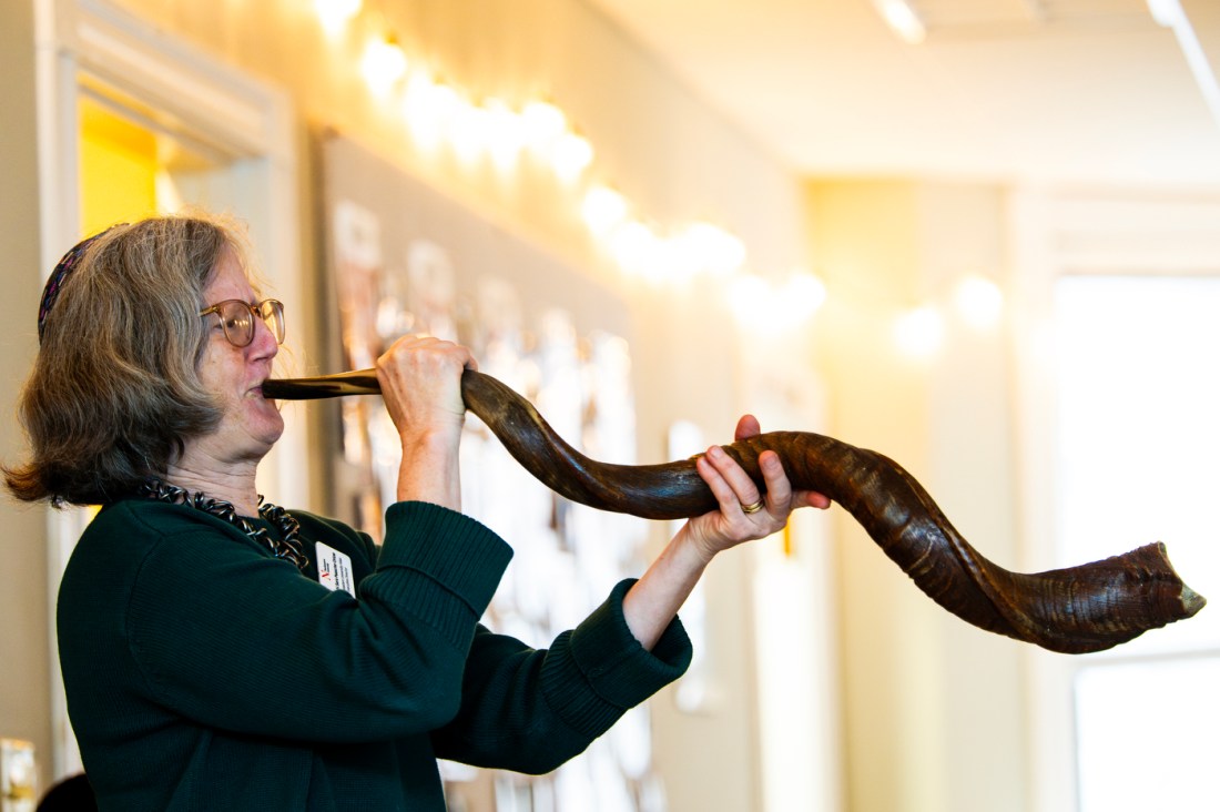 A person blows the shofar during Northeastern's October 7 memorial ceremony.