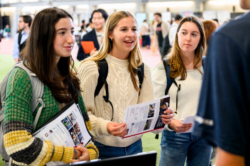 Students speak with employers at a career fair.