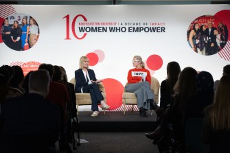 Two women sit on stage during a discussion at the International Day of the Girl event.