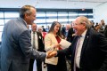 Aaron Michlewitz shaking hands with Robert DeLeo.