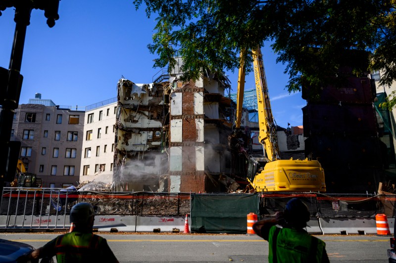 A crane working on demolishing White Hall.