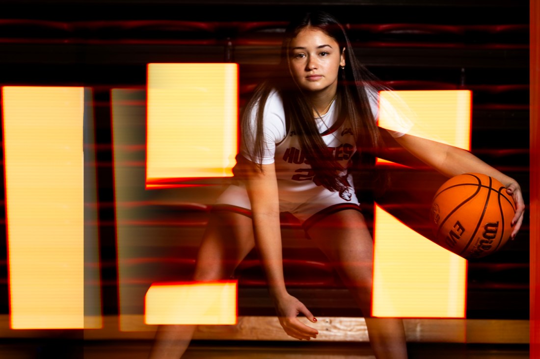 Maddie Vizza posing with a basketball